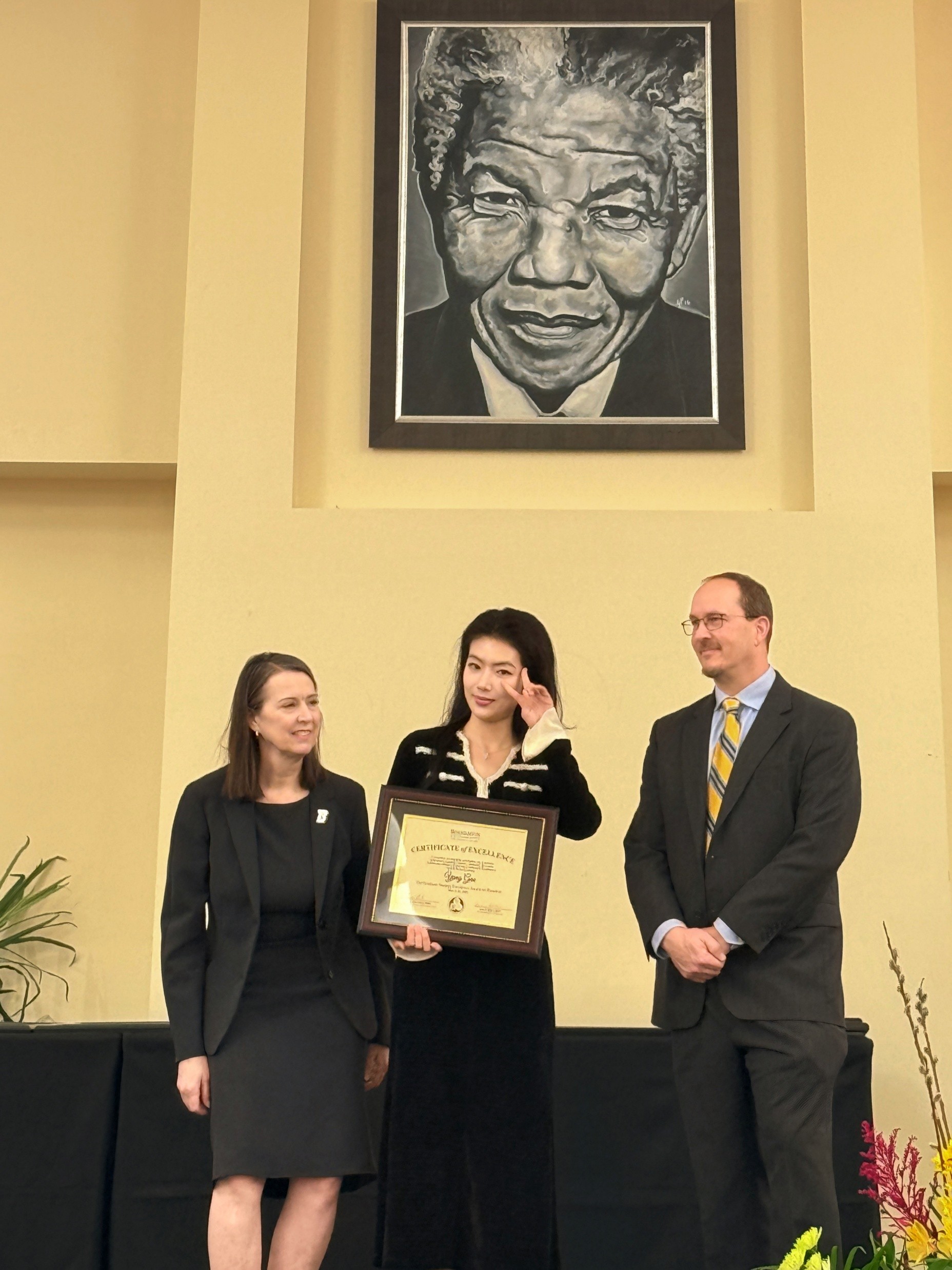 Lexi's graduation award picture with president